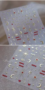 Detailed macro of 3D gold embossed star and moon nail stickers with red hearts
