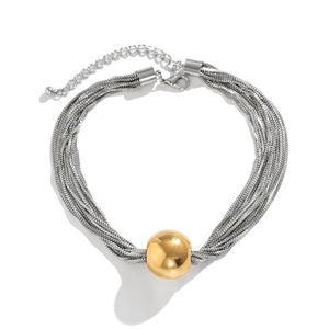 Detail of layered silver snake chains with a large gold ball pendant and lobster clasp