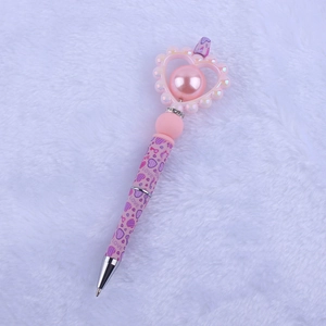 Detailed view of DIY silicone heart bead pen with pink pearls and LOVE pattern design