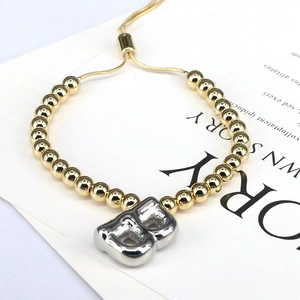Detail of adjustable gold beaded bracelet featuring a silver 3D balloon letter B charm