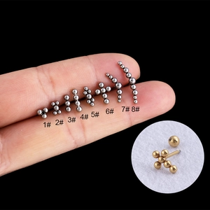 Stainless steel ball bead cross cartilage studs showing 8 styles on fingertips