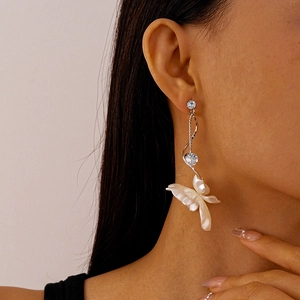 Elegant long drop flower earrings with sparkling zircons and white pearlescent petals