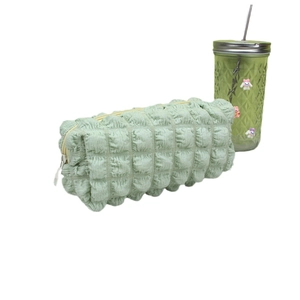 Light green bubble texture pencil case with zip closure and spacious storage design
