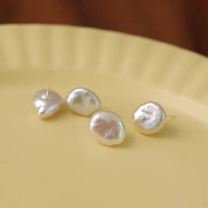 Baroque natural freshwater pearl stud earrings with S925 silver pins shown in macro view
