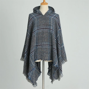 Close-up detail of blue plaid hooded poncho scarf featuring elegant fringe tassel hem