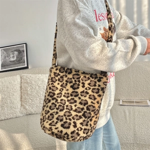 Macro shot of fluffy leopard print shoulder bag material with soft plush faux fur texture