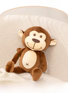 Close-up of cute brown plush monkey doll sitting on a soft white armchair in a cozy home
