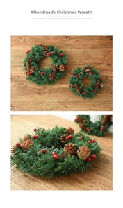 Detail view of artificial Christmas wreaths with pine cones and red berries on a wood table
