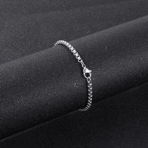Detail of silver stainless steel box chain necklace with a secure lobster clasp closure