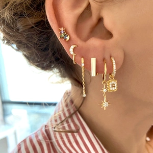 Multi-piece set of gold-plated S925 earrings with colorful zircons worn by a model