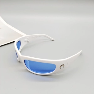 Side view of white sports sunglasses with blue mirrored lenses and crescent metal detail
