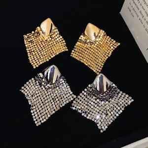 Chic gold and silver rhombus mesh tassel drop earrings on black velvet display