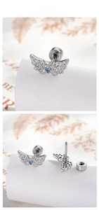 Detailed view of silver angel wing earrings with inlaid blue and white cubic zirconia