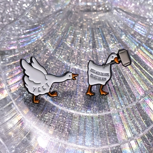Funny cartoon swan enamel pins with hammer and 'Yeet' text on iridescent background