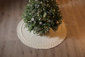 Detail of 48-inch cream white chunky knit Christmas tree skirt with braided edge trim