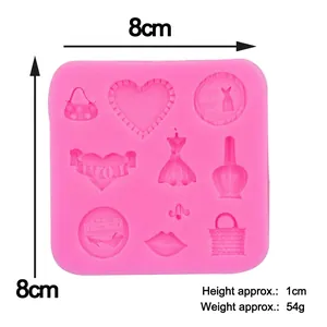 Pink silicone makeup mold for fondant cakes featuring dress handbag and high heels shapes