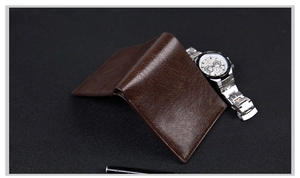 Close-up of brown textured leather men wallet with professional lighting and accessories