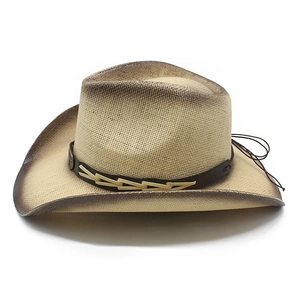 Detail of western straw cowboy hat featuring brown leather band and intricate weaving