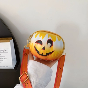 Close-up of Halloween pumpkin shoulder bag with smiling face and striped strap