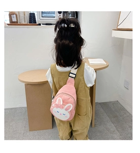 Rear view of a child wearing a cute pink rabbit canvas chest bag with adjustable strap