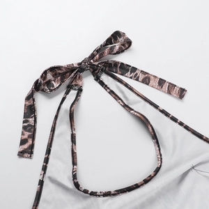 Detail of leopard print halter neck tie and fine stitching on a slim fit jumpsuit