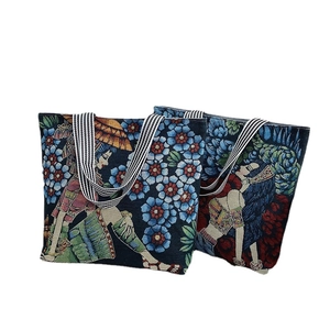 Ethnic tote bags in colorful woven fabric with striped top handles on white background