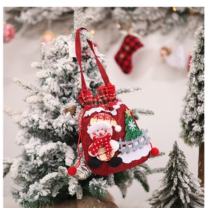 Close-up of red linen Christmas gift bag with a 3D snowman and pompom drawstring detail