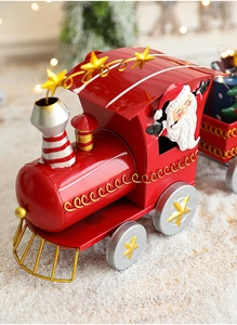 Detailed close-up of a red metal Christmas train decoration with a Santa Claus figure
