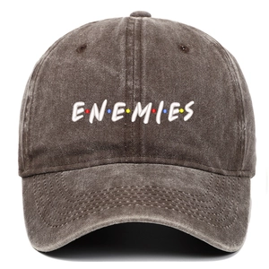 Detail of ENEMIES embroidery with colorful dots on a vintage washed cotton baseball cap