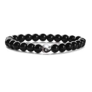 Close-up of black matte bead bracelet featuring a heart-shaped Yin Yang symbol charm
