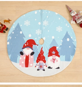 Detail of light blue Christmas tree skirt with festive gnomes and snowflake prints