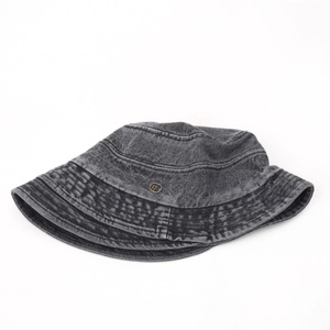 Detail of vintage washed denim bucket hat featuring stitching and metal logo