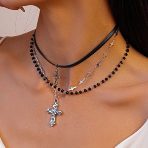 Detail of layered leather choker with silver cross pendants and black beads