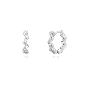 Macro view of silver wave-shaped hoop earrings with sparkling white cubic zirconia