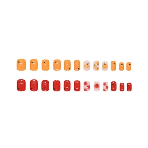 Short orange and red press-on nails set with fruit and star designs, 24 pieces pack