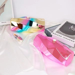 Irregular geometric acrylic evening clutch with rainbow metallic finish on silk background