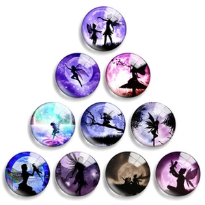 Detailed view of luminous round glass cabochons featuring glowing fairy silhouettes
