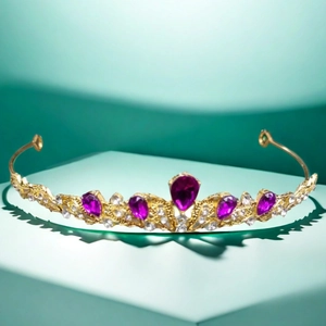 Detailed view of luxury gold tiara with purple pear-shaped stones on a pedestal