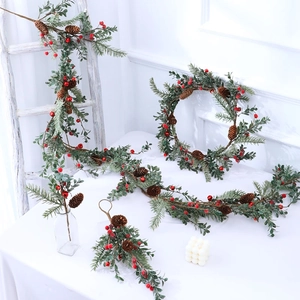 Artificial Christmas wreath with pine needles, red berries and natural cones for decor