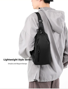 Rear view of model wearing minimalist black water-resistant sling bag with adjustable strap