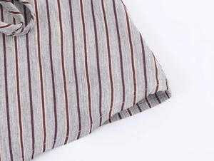 Close-up of gray and burgundy striped fabric showing quality stitching and cotton texture
