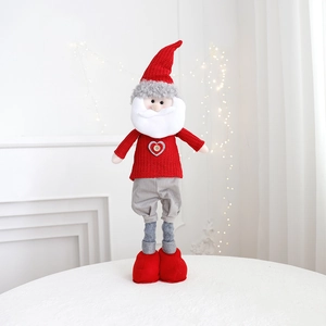 Close-up of Santa Claus doll made of knitted fabric with plush details for holiday decor