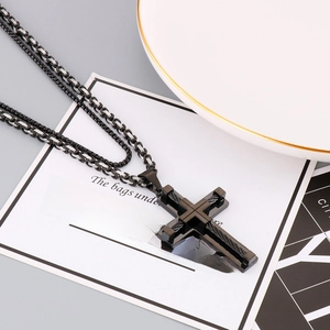 Detail of cross pendant with wire texture and double box chain for men's jewelry