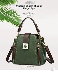 Detail of vintage green bucket bag featuring brown handles and square metal lock clasp