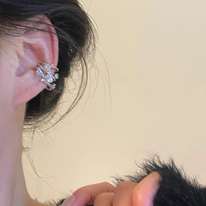 Detail of silver layered zircon ear cuff showing actual fit on a model's ear cartilage