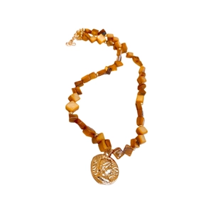Classic amber beaded necklace with a golden vintage portrait pendant on white background