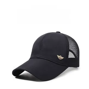 Close-up of the breathable mesh panel and gold metal logo on a black baseball cap