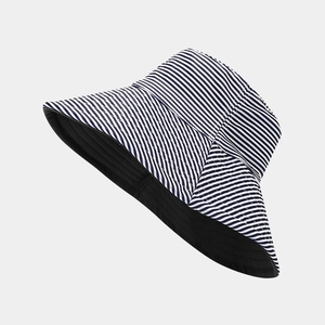 Detail of blue and white striped fisherman hat with wide brim for UV sun protection