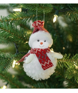 Detail view of plush snowman ornament with red and white scarf on Christmas tree