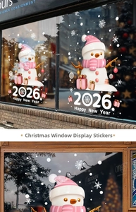 Detail of pink snowman window stickers with 2026 Happy New Year motifs on glass